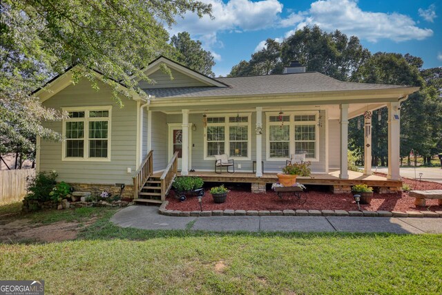 view of front of home featuring a front yard and a porch