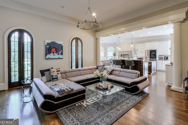 living room featuring a wealth of natural light, crown molding, and hardwood / wood-style floors