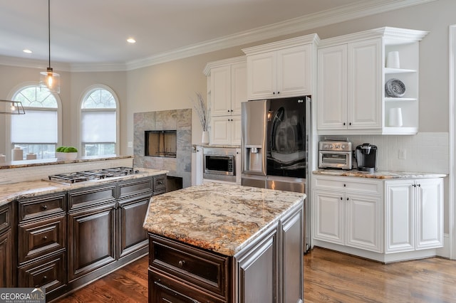 kitchen featuring white cabinets, crown molding, dark hardwood / wood-style floors, and stainless steel appliances