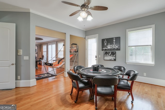 dining space featuring ceiling fan, light hardwood / wood-style flooring, and ornamental molding