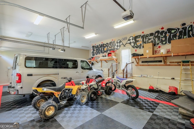 garage with a workshop area and a garage door opener