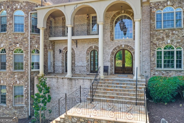 property entrance with a balcony and french doors