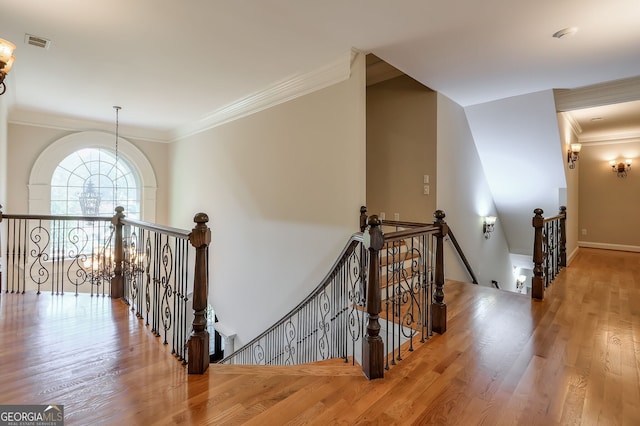 stairway featuring crown molding and hardwood / wood-style floors