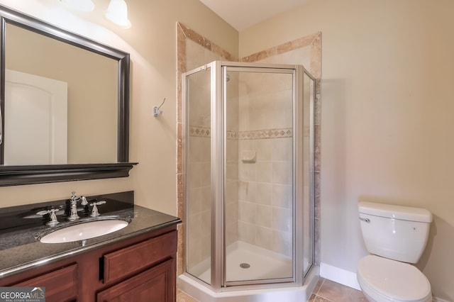 bathroom with an enclosed shower, toilet, vanity, and tile patterned floors