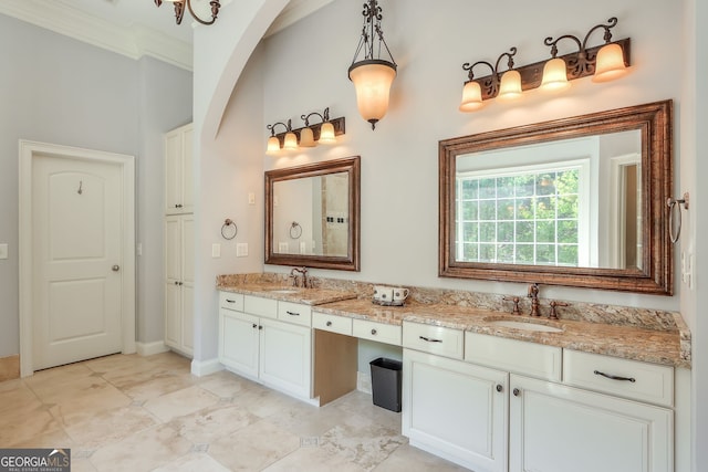 bathroom with tile patterned flooring, ornamental molding, and dual bowl vanity