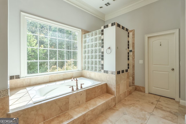 bathroom with tiled tub, tile patterned floors, crown molding, and a wealth of natural light