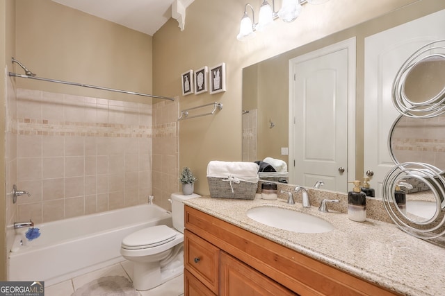 full bathroom featuring tiled shower / bath, toilet, tile patterned floors, and vanity