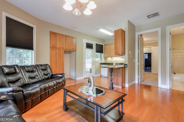 living room featuring light hardwood / wood-style floors and a chandelier