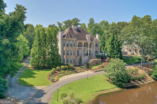 birds eye view of property with a water view