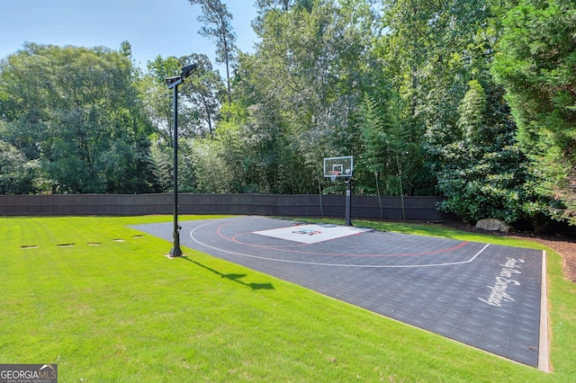 view of sport court with a yard