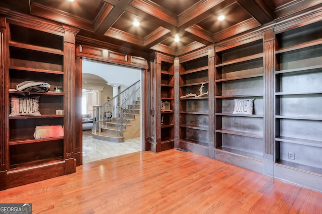 interior space with light hardwood / wood-style flooring, built in features, crown molding, and coffered ceiling