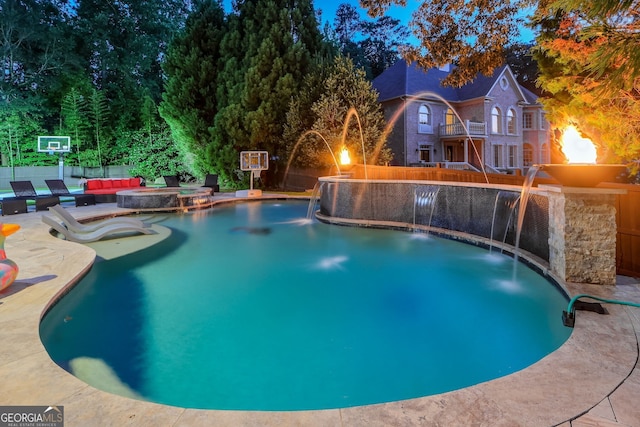 view of pool featuring pool water feature and a patio area