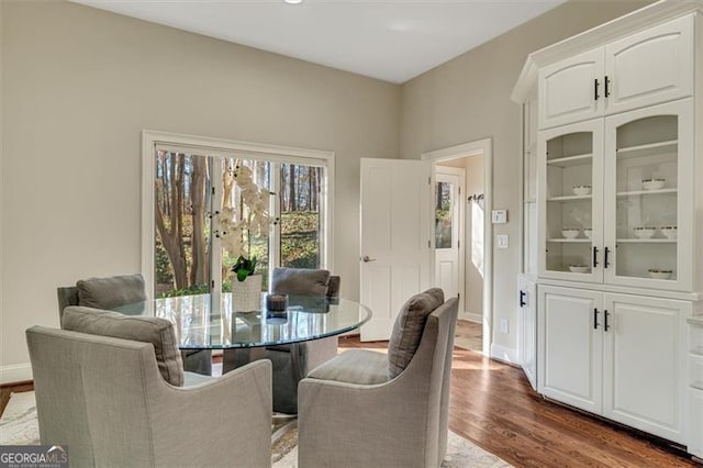 dining space with dark hardwood / wood-style floors