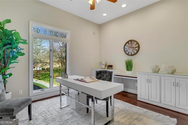 office space with dark hardwood / wood-style flooring, ceiling fan, and a healthy amount of sunlight