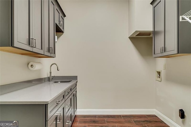 laundry room featuring cabinets, sink, and washer hookup