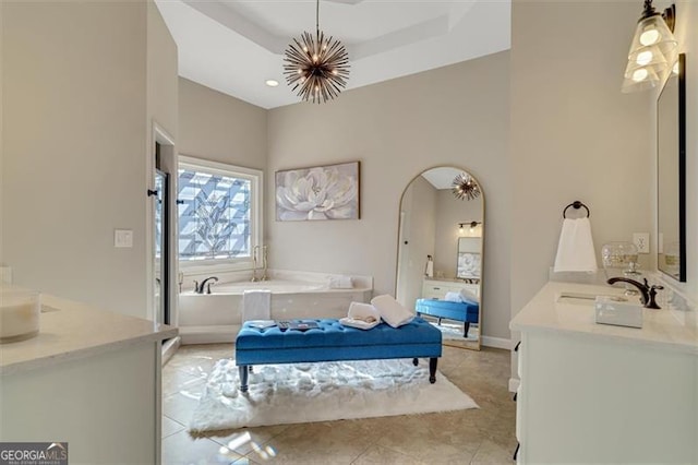 bathroom with a raised ceiling, tile patterned floors, vanity, and an inviting chandelier