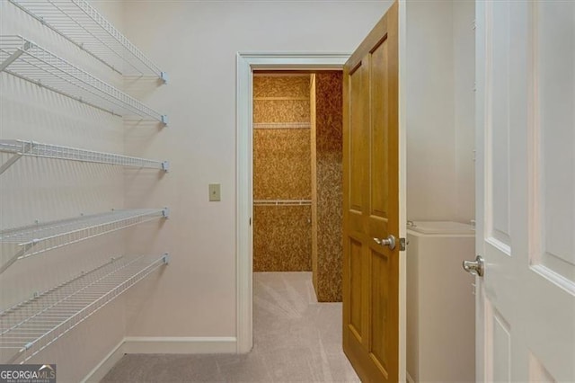 spacious closet featuring light carpet