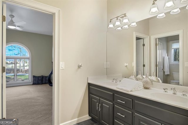 bathroom featuring ceiling fan, vanity, and toilet