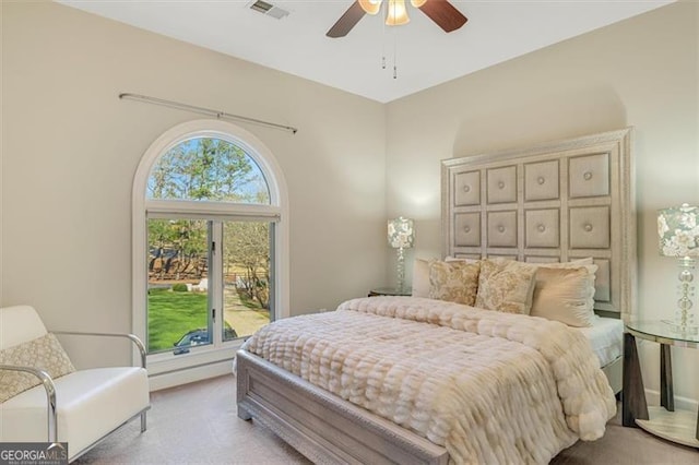 bedroom featuring ceiling fan and light carpet