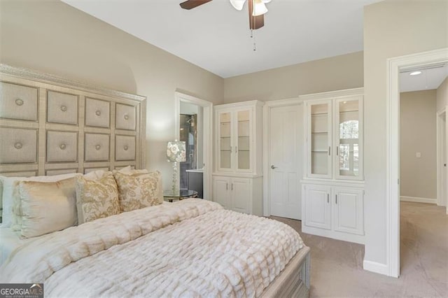 bedroom featuring light carpet and ceiling fan