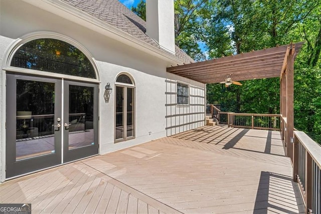 wooden deck featuring a pergola and french doors