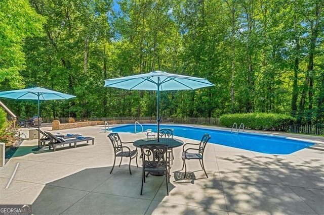 view of swimming pool featuring a patio area