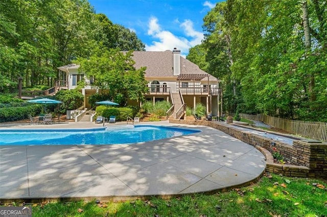 view of pool with a patio and a wooden deck