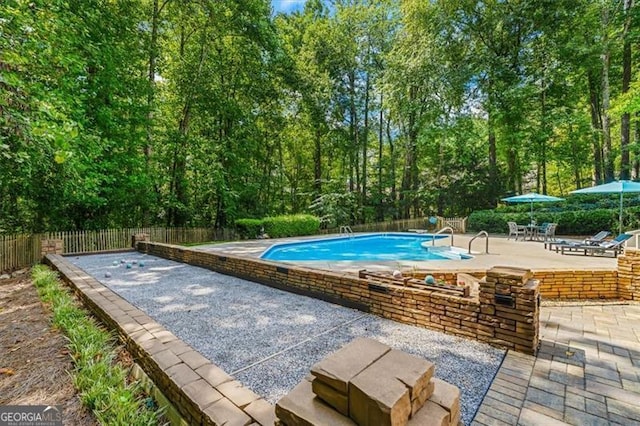 view of swimming pool featuring a patio area