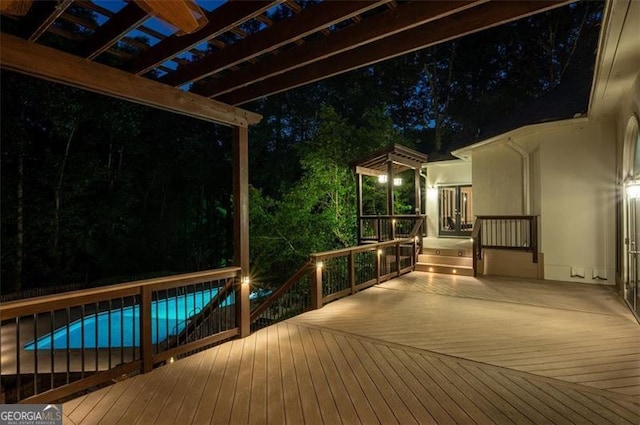 deck at twilight with a pergola and french doors