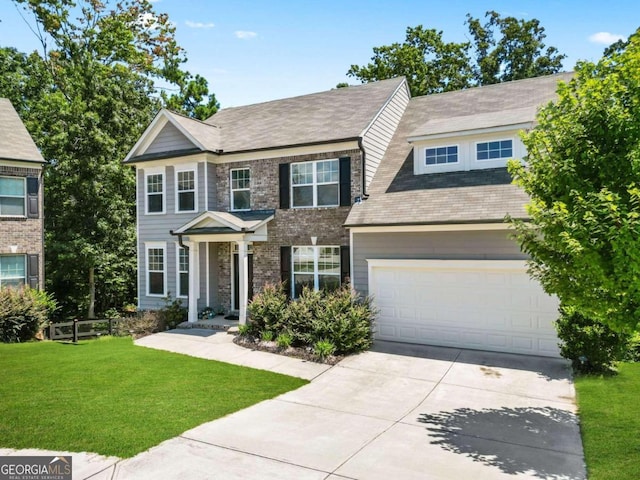 view of front facade with a garage, driveway, and a front yard