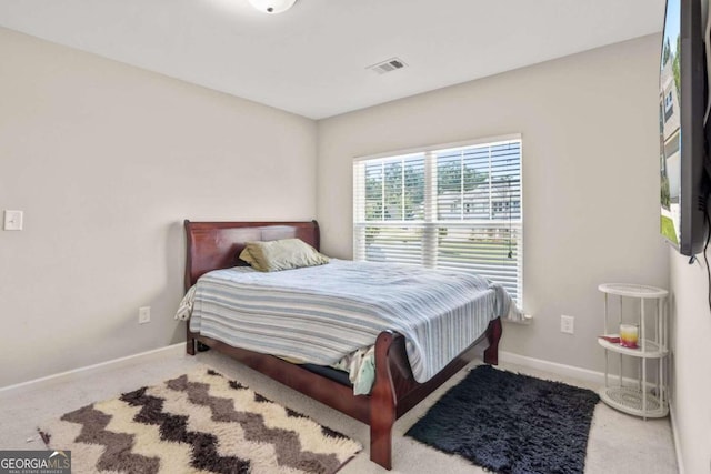 carpeted bedroom featuring visible vents and baseboards