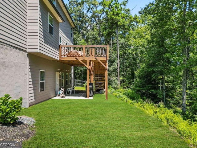 view of yard featuring a deck, a patio, and stairway