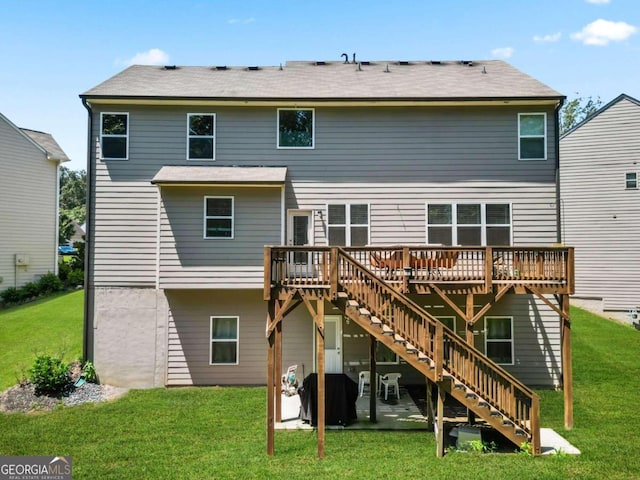 back of house featuring a lawn, stairway, and a wooden deck