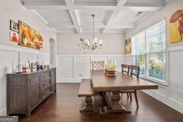 dining room featuring arched walkways, beam ceiling, dark wood-type flooring, and visible vents