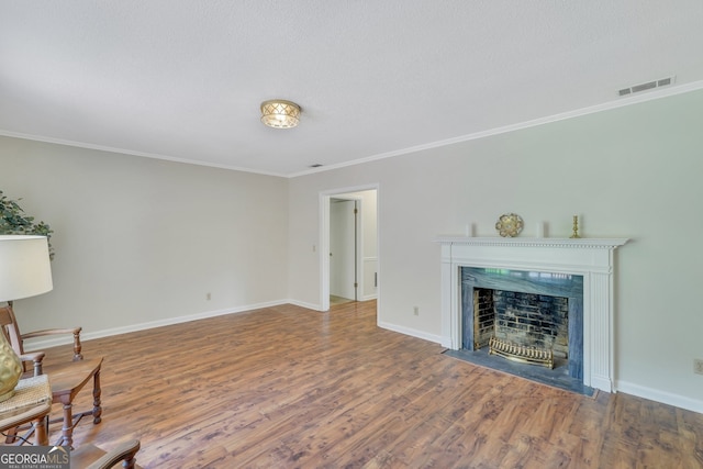 living room with hardwood / wood-style flooring and crown molding