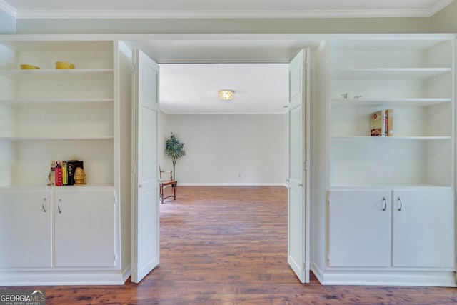 hall with crown molding, wood-type flooring, and built in features