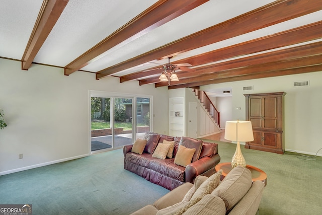 living room featuring ceiling fan, beamed ceiling, and carpet