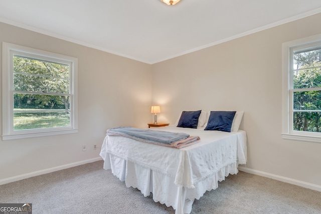 bedroom with light colored carpet and crown molding