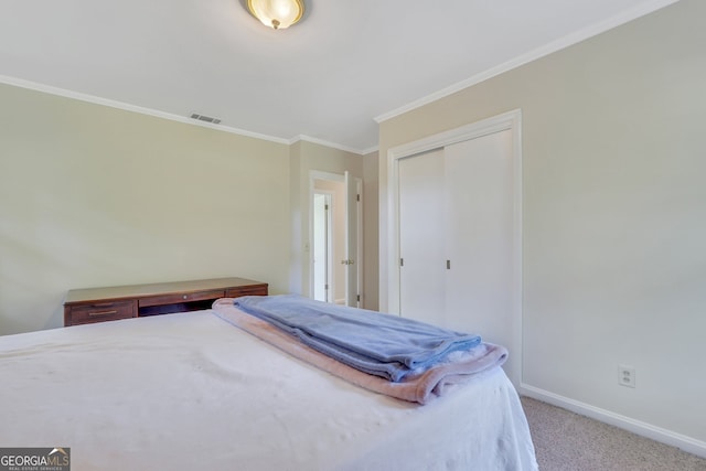 bedroom with carpet, a closet, and crown molding