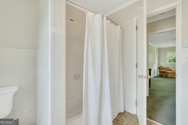 bathroom with tile walls, toilet, and ornamental molding