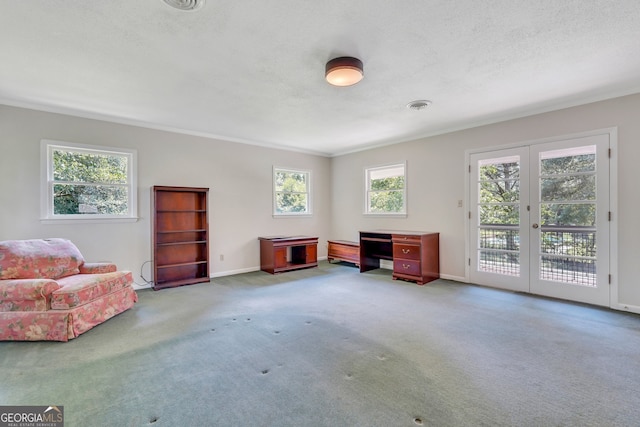 unfurnished living room featuring french doors, plenty of natural light, ornamental molding, and carpet