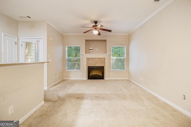 unfurnished living room with light carpet, plenty of natural light, a fireplace, and baseboards