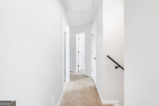 hallway featuring light colored carpet