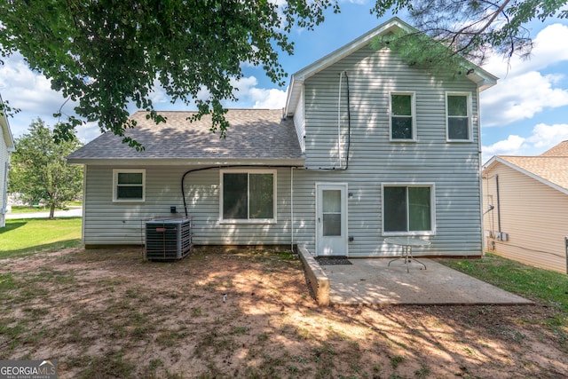 rear view of house with a patio area and cooling unit