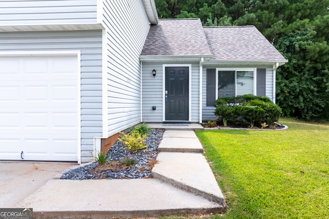 entrance to property with a lawn and a garage