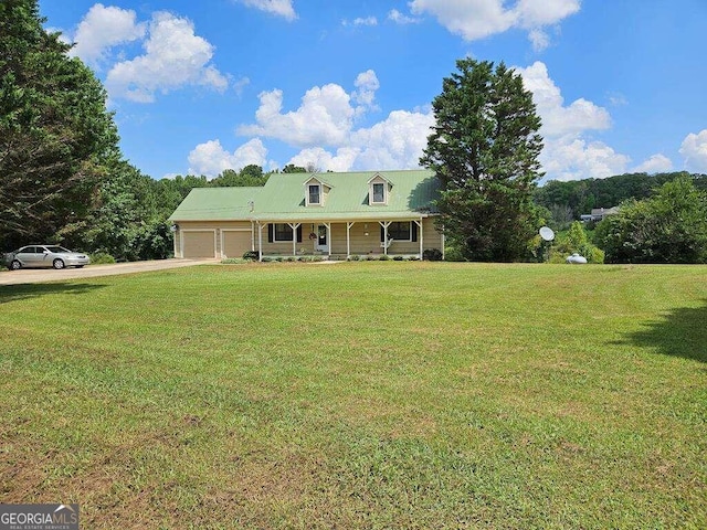 view of front of property featuring a porch, a garage, and a front lawn