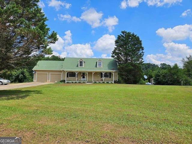 view of front of house featuring a porch, a garage, and a front lawn