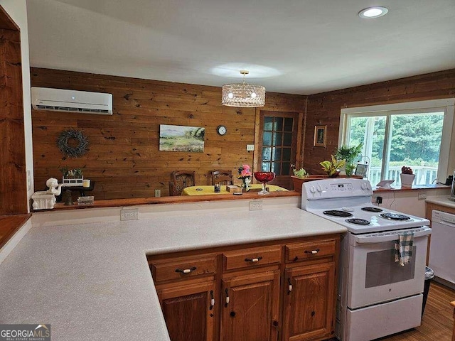 kitchen featuring white appliances, a wall unit AC, and wooden walls