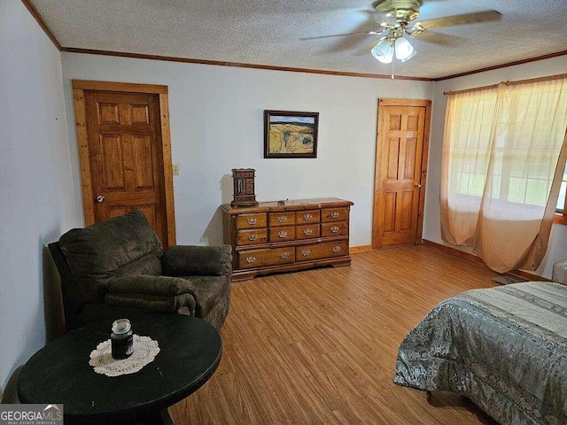 bedroom featuring hardwood / wood-style floors, ceiling fan, and a textured ceiling