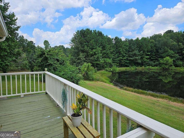 wooden terrace featuring a yard